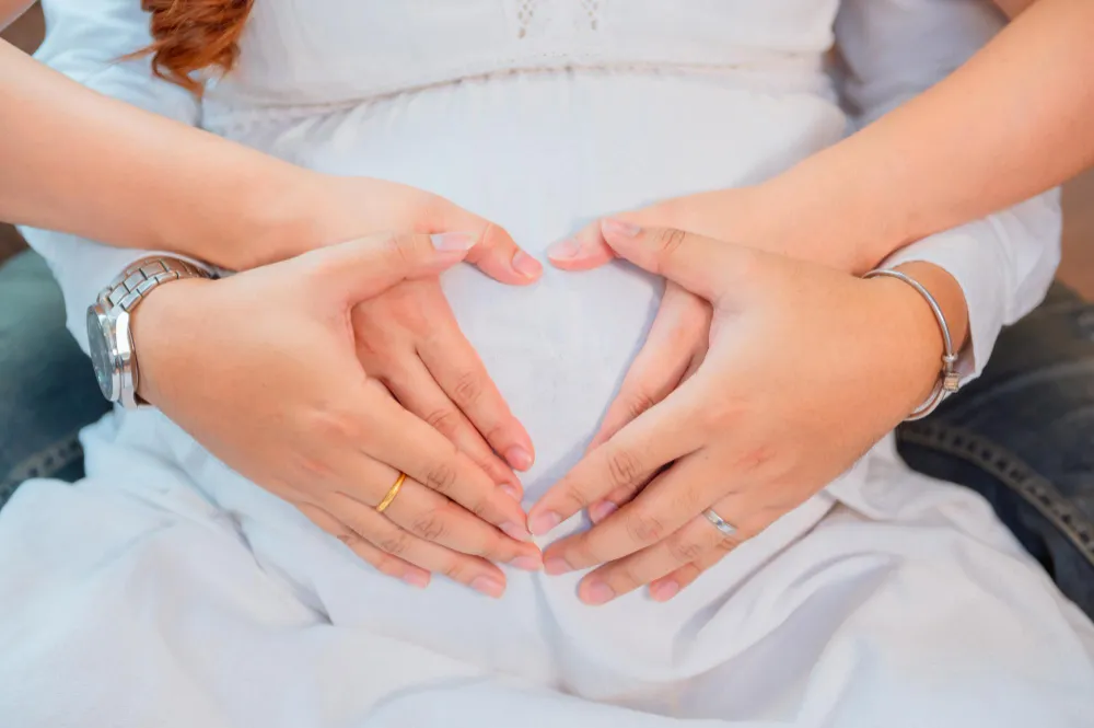 Making heart shape by couples from hand in woman wound - How to prepare for IVF concept